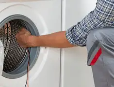 Dryer repair technician diagnosing and servicing a clothes dryer in Minneapolis, MN