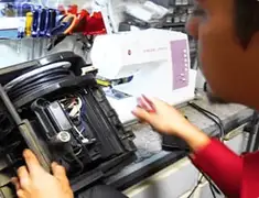 Vacuum repair technician servicing internal components on a workbench in Minneapolis, MN
