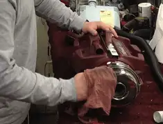 Vacuum repair technician cleaning and servicing a vacuum motor in Minneapolis, MN